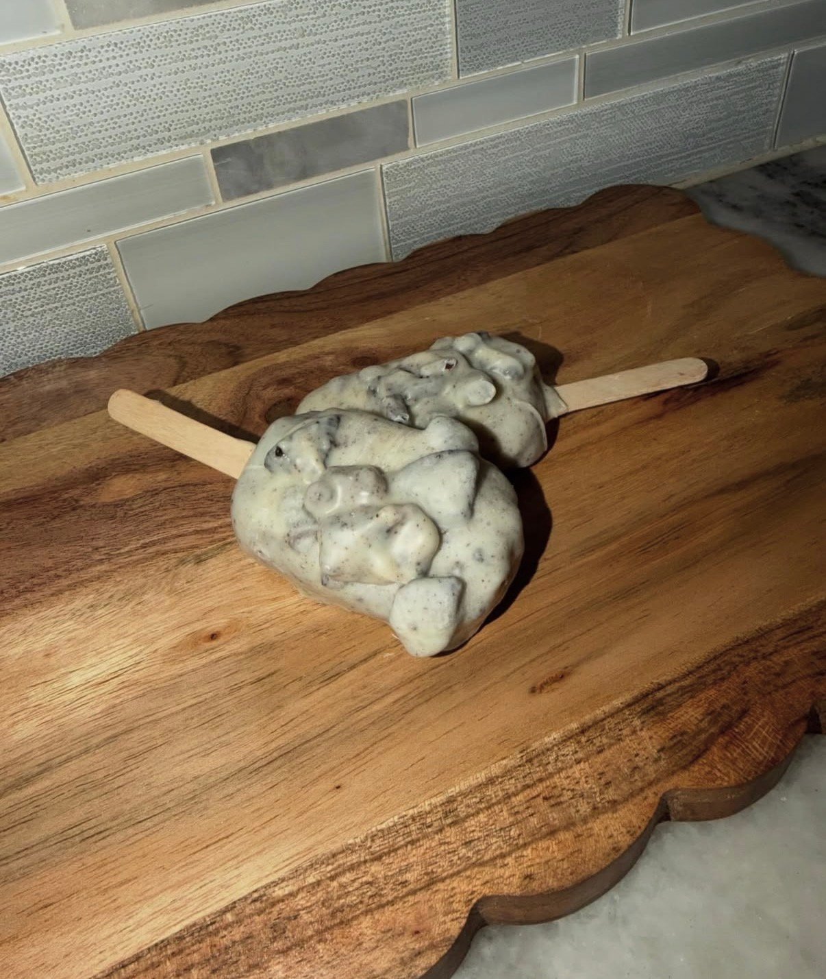 Cookies and cream cakesicles on a board